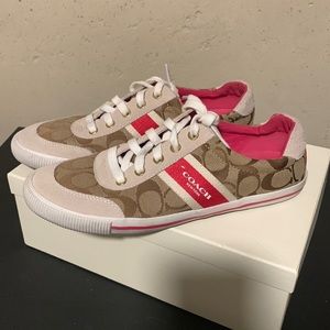 These are a Tan and pinkish red 9.5 women pair of Coach sneakers